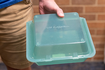 a green reusable clam shell container