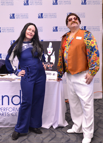 two UIS employees dressed up in 1960's outfits for 2025 Celebration