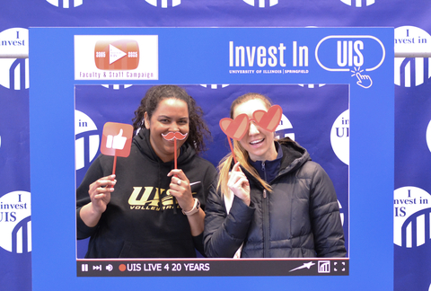 two UIS employees at the 2025 Celebration playing with party favors
