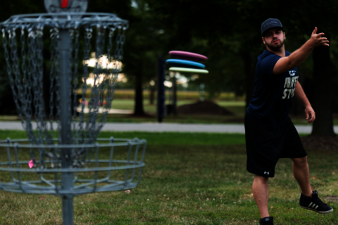 Student playing disc golf