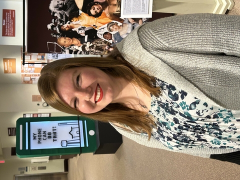 Katie Brethorst standing in the Grayslake Heritage Center and Museum smiling at the camera.