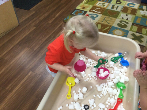 child playing in sensory table