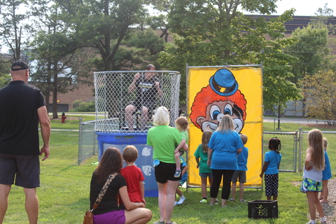 children participating in dunking a teacher