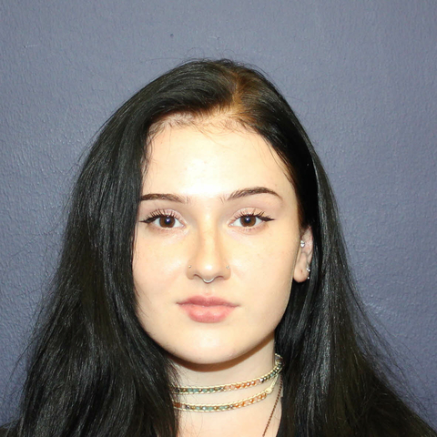 Staff photo of Jenna Baker. Female with straight black hair and a choker necklace