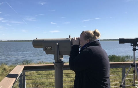 UIS employee at a telescope