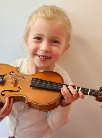 little girl holding violin