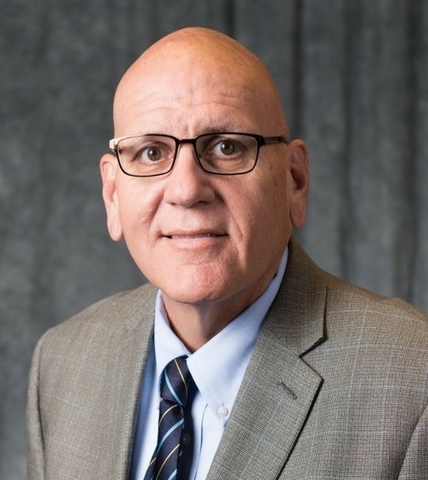 Dennis Papini head-and-shoulders business attire photo