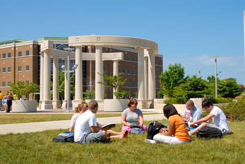 students and their families sitting out on the quad by the colonnade