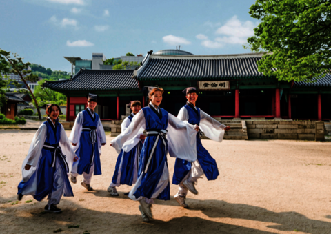 Group of 5 SKKU students dancing outside a traditional Korean building