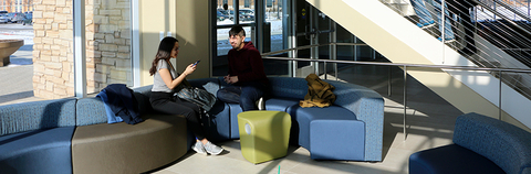 two students on couches in the Student Union
