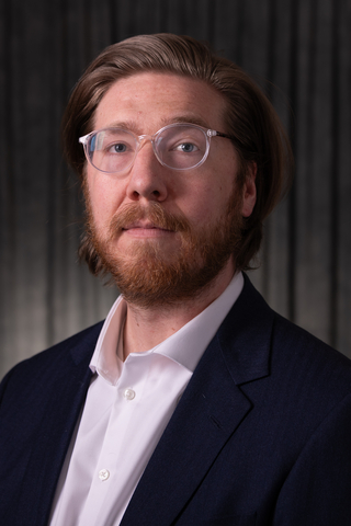 Matt Suda head-and-shoulders photo in business attire