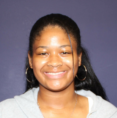 Staff photo of Taleah Dammons. Smiling women with large hoop earrings. 