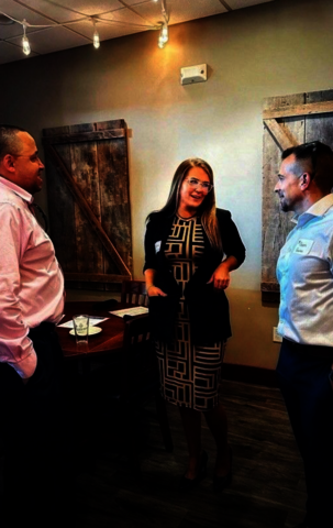 Dana Goodrum speaking with two fellow alumni at the first UIS Professionals Networking event in 2025.