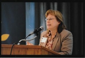 Vickie Cook speaking at a conference.