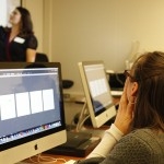 student working at a computer during class