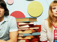 a stack of books with a person on each side