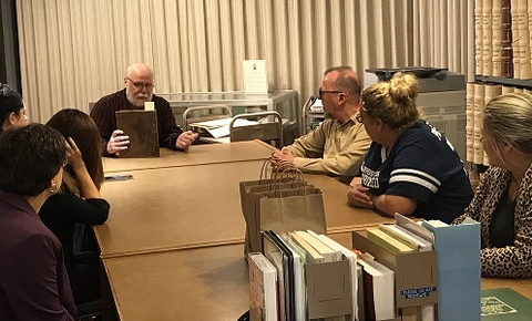 Tom Woods presenting a book from the archives