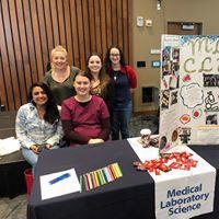 The MLS club at a table in the Student Union Ballroom