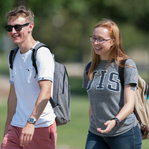 Two students walking on the quad