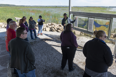 UIS employees gathered around information panels
