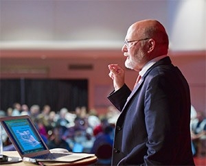 Ray Schroeder speaking at a conference.