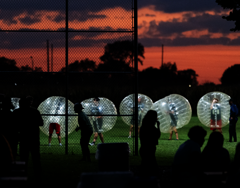 Students playing knockerball in inflatable bubbles at RecPalooza