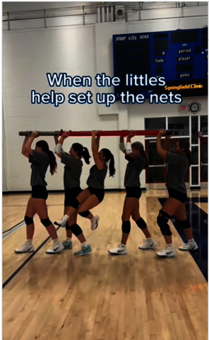 Screenshot of TikTok video portraying UIS Volleyball players setting up the nets.
