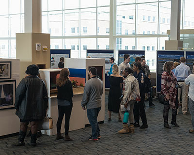 people standing in gallery exhibit