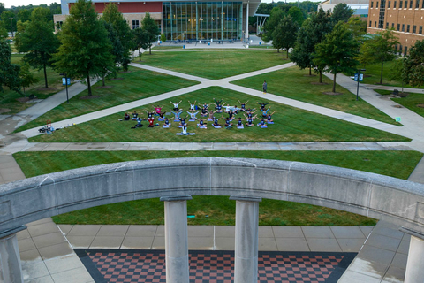 students doing yoga on the quad in front of the colonnade