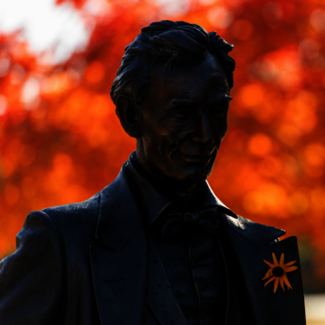 Statue of Abe Lincoln with orange flower in his lapel