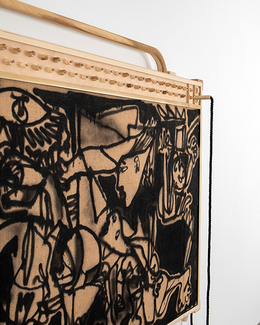 Abstract painting with black and brown tones on a wooden frame, leaning against a white wall.