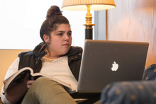 A student studies on her laptop at home.