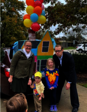 family dressed like the characters from Disney's "Up" in front of their decorated car