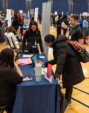 Students filling out papers at the Career Connections Expo