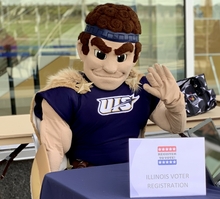 Photo of person sitting at Illinois voter registration desk