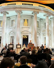 Chancellor Gooch speaks in front of a replica of the White House.