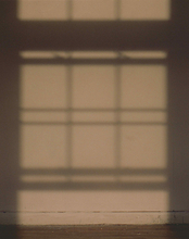 Artwork by Ruby Que that shows the shadow of a window on a wall