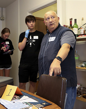 Students and an instructor investigate clues during a CSI camp.