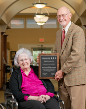 Hannah and Richard McDaniel posing for a photo with the award.