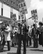 Women holding signs that say "ERA" march through the streets of Springfield in 1982 as part of an Equal Rights Amendment rally.