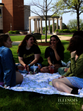 Friends having a picnic on the quad.