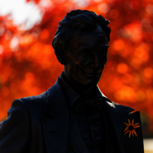 Statue of Abe Lincoln with orange flower in his lapel