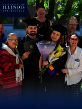A family taking a picture at graduation.