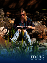 Student reading by the Koi Pond.