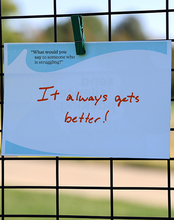 Sign clipped to a fence reads, "It always gets better!"