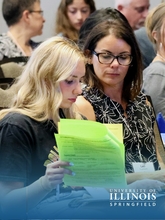 Mother and daughter review paperwork at orientation.