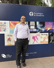 Man standing in front of a poster display at Tecnológico de Monterrey.