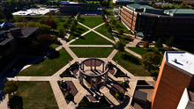 Aerial view of a campus courtyard with surrounding buildings.