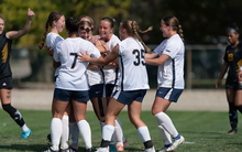 Women's soccer team celebrates a goal