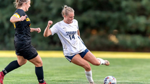 Addi Wittenberg playing soccer in white UIS uniform